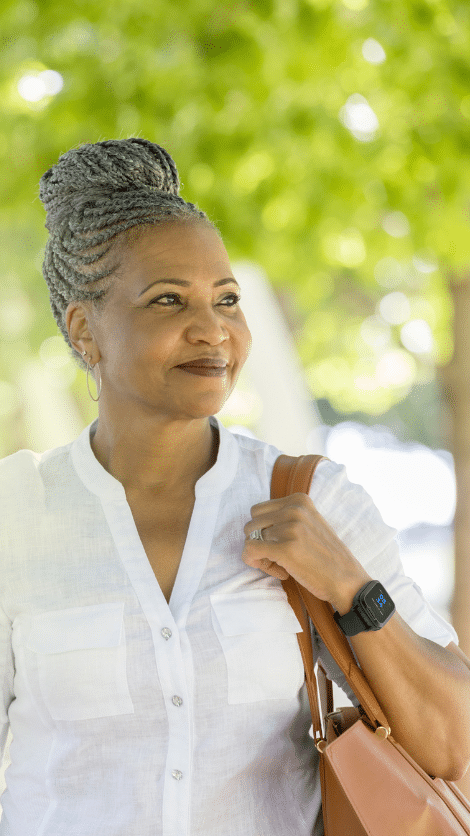 Woman wearing smartwatch in park